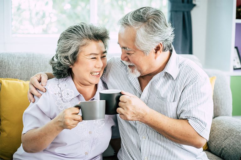 Elderly Couple Talking together and drinking coffee or milk Elderly Couple Talking together and drinking coffee or milk