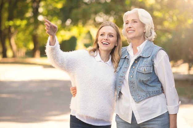 Happy aging woman and mature daughter