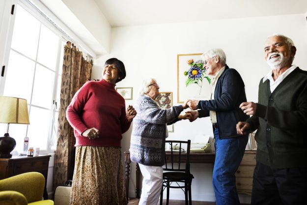 Senior friends dancing together at home How Senior Living In Hamburg, PA Helps Residents With Chronic Illness Enjoy Their Best Life