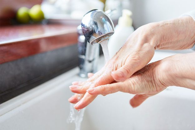 Old woman washing hands with soap Old woman washing hands with soap