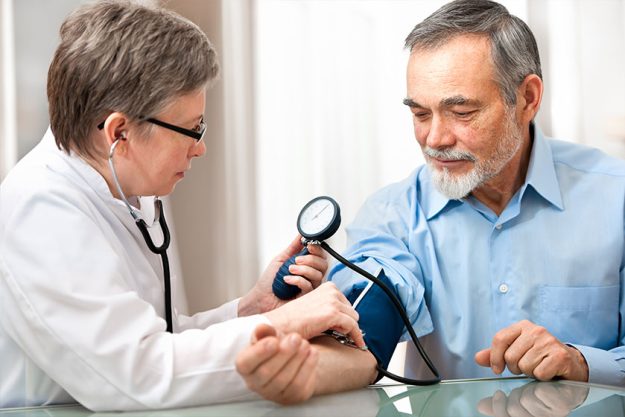 physician checking high blood pressure examining old male patient physician checking high blood pressure examining old male patient