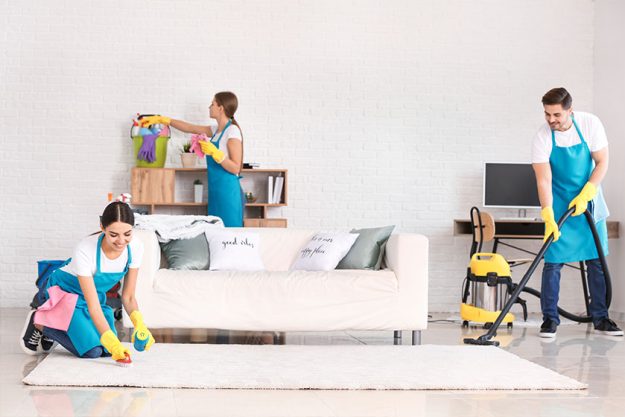 Team of janitors cleaning flat Team of janitors cleaning flat