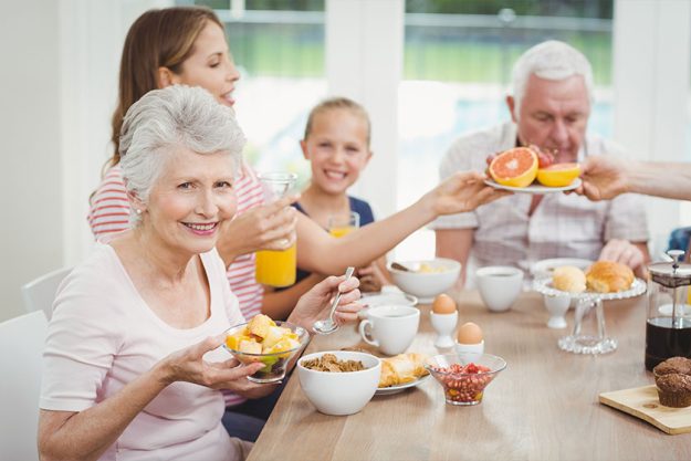 Family eating fruits during breakfast