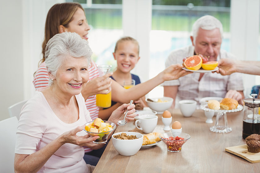 Family eating fruits during breakfast