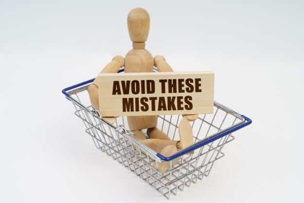A wooden man sits in a shopping basket, holding a sign in his hands – Are you ready for a change wooden man