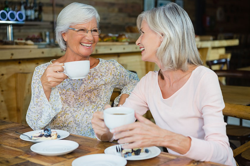 Senior friends having coffee and breakfast