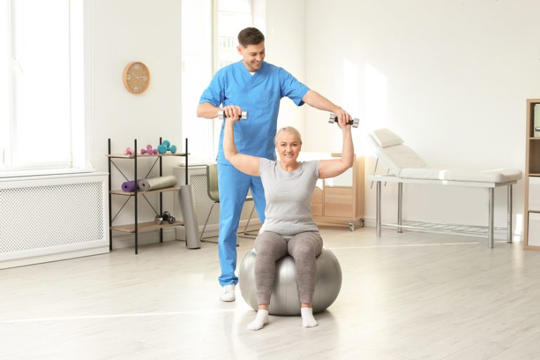 Physiotherapist working with patient in clinic. Rehabilitation therapy Lifestyle Changes You Should Make As You Age In Retirement Apartments In Lehigh County, PA To Reduce Arthritis Pain