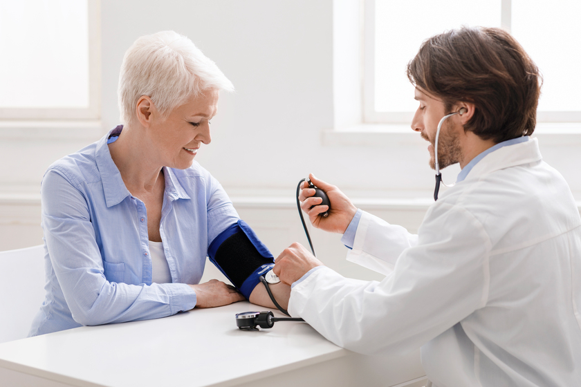 Doctor measuring blood pressure of senior woman at clinic Wellness And Health Trends to Check Out While Living in An Assisted Living Property in Lawrence, IN