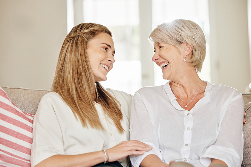 All that matters is love. a mother and daughter sitting on the couch at home