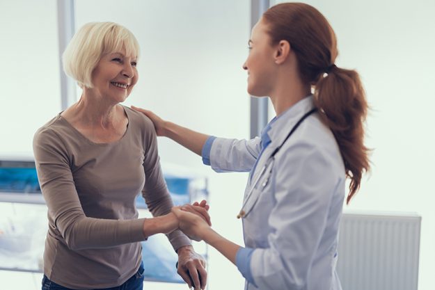 Delighted woman is taking leave of doctor Delighted woman is taking leave of doctor