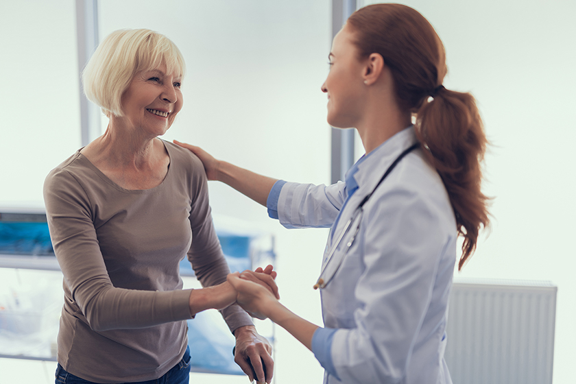 Delighted woman is taking leave of doctor