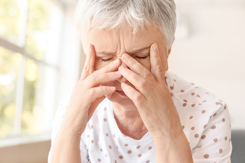 Stressed senior woman suffering from headache Stressed senior woman suffering from headache