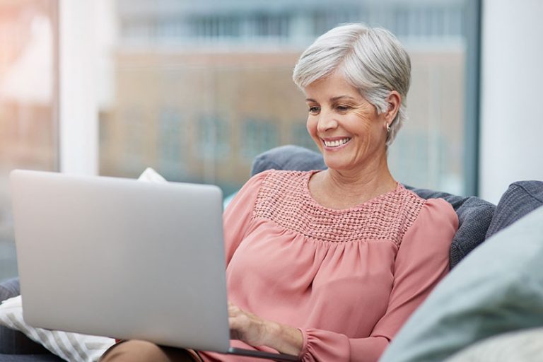 Shot of a cheerful mature woman using her laptop Shot of a cheerful mature woman using her laptop