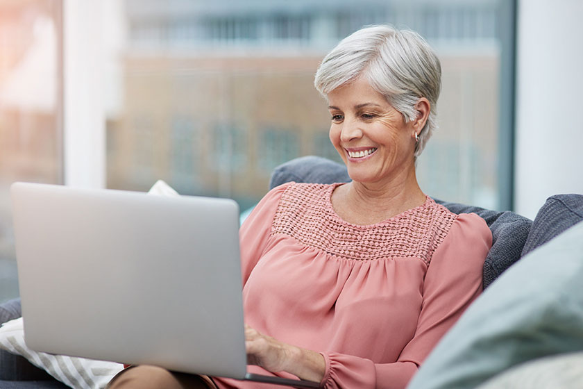 Shot of a cheerful mature woman using her laptop Shot of a cheerful mature woman using her laptop