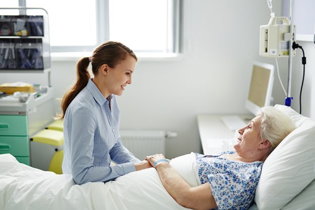 woman-talkingWoman talking to senior woman in clinic-to-senior-woman Woman talking to senior woman in clinic