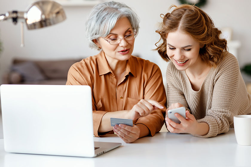 Young granddaughter smiling and showing smartphone Young granddaughter smiling and showing smartphone