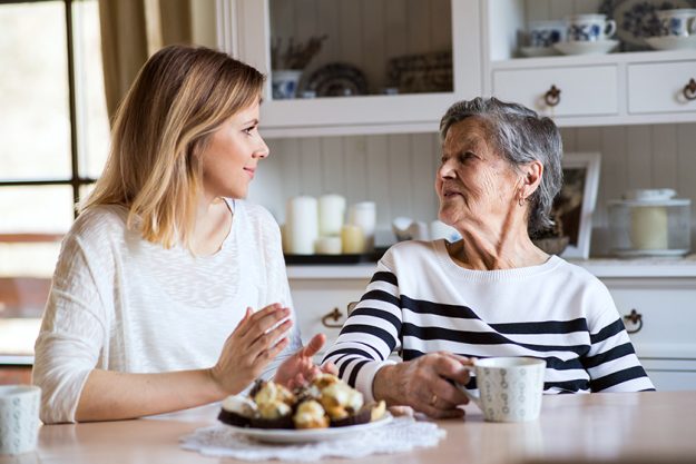 An elderly grandmother with an adult granddaughter