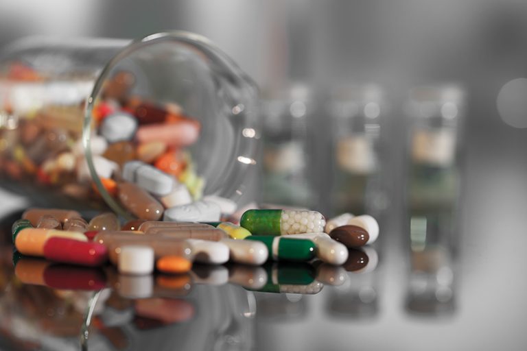 Colorful tablets with capsules and pills on background Colorful tablets with capsules and pills on background
