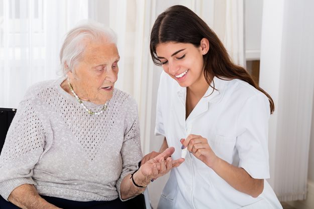 Female Doctor Checking Blood Sugar