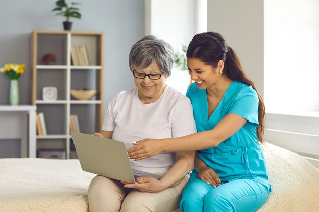 Friendly home care nurse teaching happy senior women Friendly home care nurse teaching happy senior women