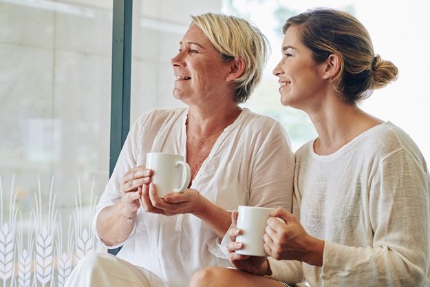 Happy middle-aged woman and her adult daughter