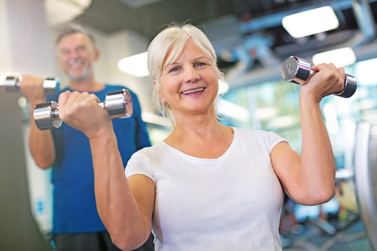 Senior couple exercising in gym Senior couple exercising in gym