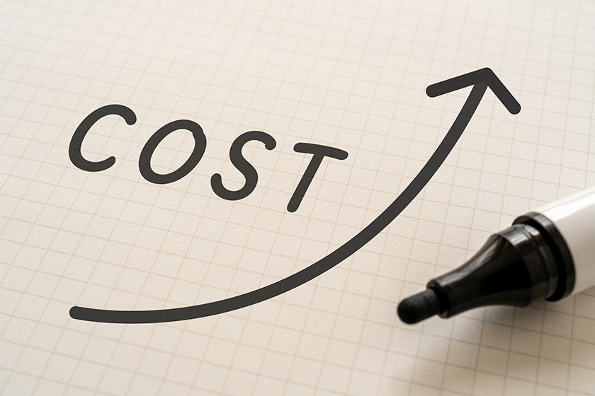 White paper written "COST" with markers