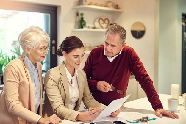 Senior couple, accountant and documents in finance, budget or agreement for consultation at home. Happy elderly man and woman with consultant or lawyer for financial planning, paperwork or investment Senior couple, accountant and documents in finance, budget or agreement for consultation at home. Happy elderly man and woman with consultant or lawyer for financial planning, paperwork or investment