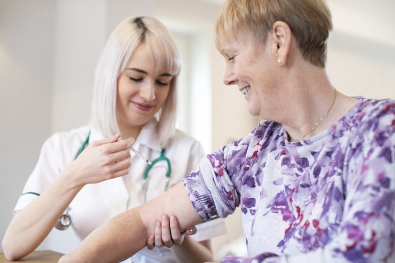 Female Nurse Giving Senior Woman Injection In Arm With Syringe What You Need To Know About Flu Prevention In A Senior Living Property In Gutsville, PA