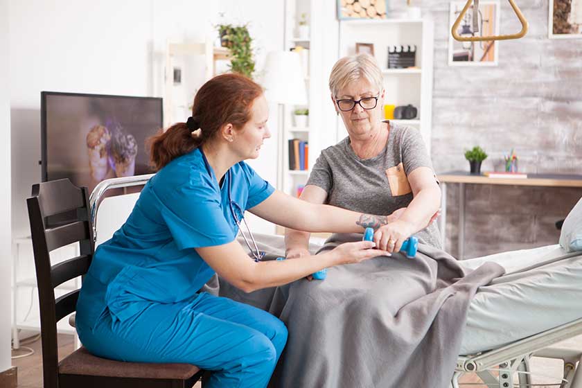 Senior woman training with physiotherapist in nursing home Senior woman training with physiotherapist in nursing home