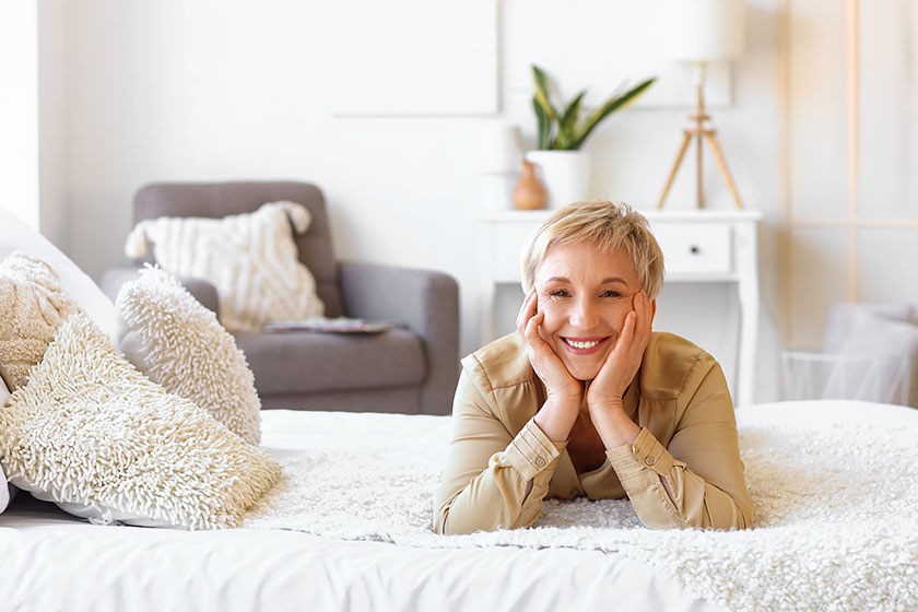 Mature woman lying in bedroom