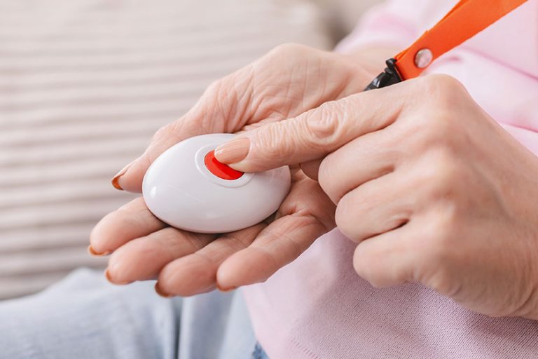 Senior woman hand pressing Alarm Button, Senior woman hand pressing Alarm Button,