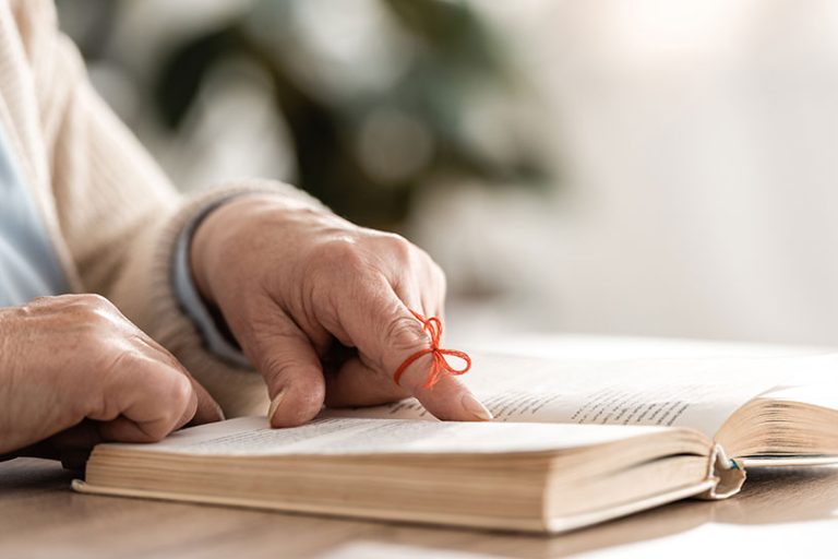 Cropped view of senior woman with alzheimers disease string human finger reminder Cropped view of senior woman with alzheimers disease string human finger reminder