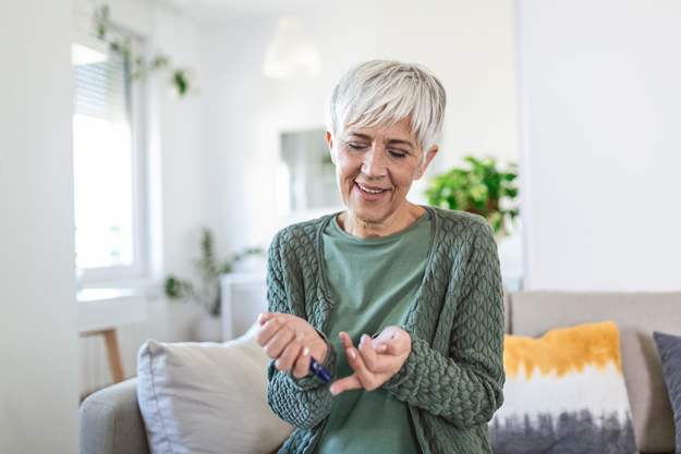 Mature Woman testing for high blood sugar