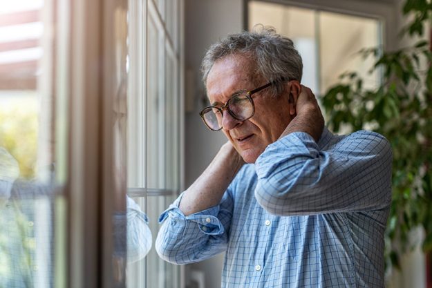 Senior man suffering from neck pain Senior man suffering from neck pain