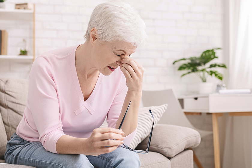 Senior woman with vision problems using phone