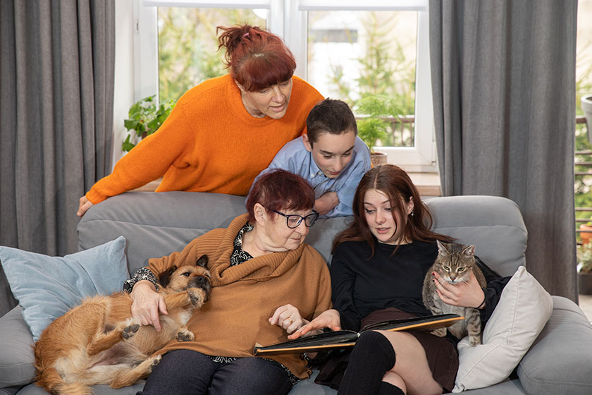 Family is looking at photo book in the living room Family is looking at photo book in the living room
