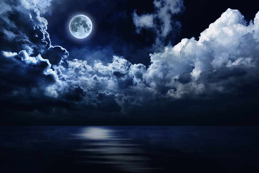 Full moon in night sky over water Full moon in night sky over water