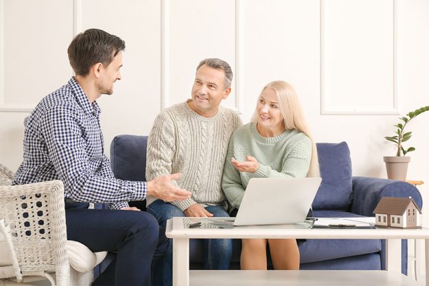 Male real estate agent working with mature couple Male real estate agent working with mature couple