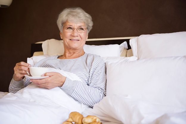 Mature woman in bed with food Mature woman in bed with food