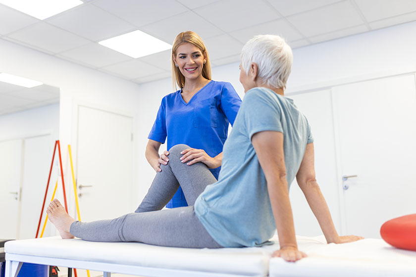 Physiotherapist massaging and kneading a patient’ leg Physiotherapist massaging and kneading a patient' leg