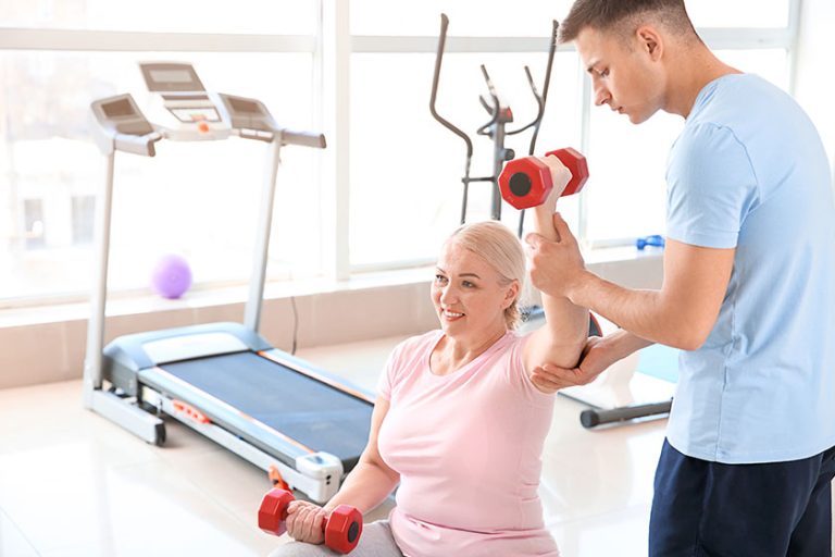 Physiotherapist working with mature patient Physiotherapist working with mature patient