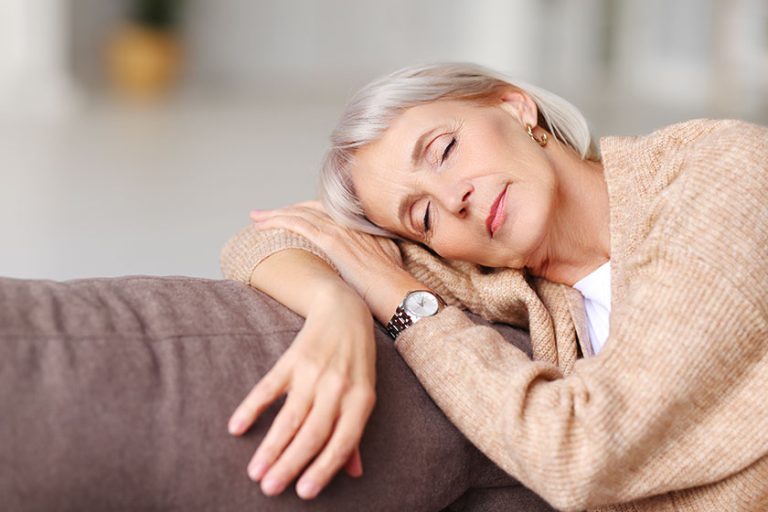 Relaxed middle aged female leaning on hand