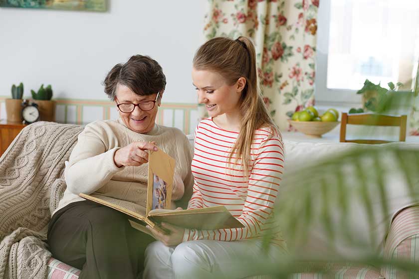 Grandma and granddaughter watching photo album Grandma and granddaughter watching photo album