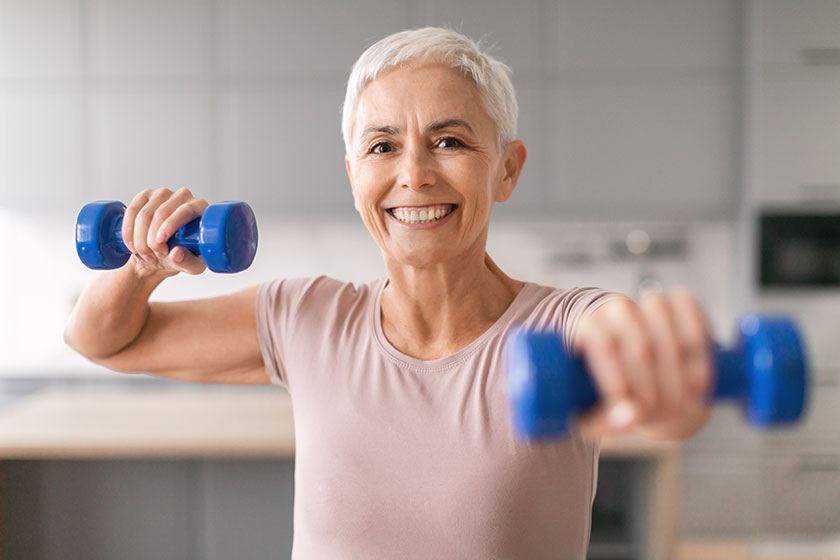 Home workout. Happy mature woman exercising Home workout. Happy mature woman exercising