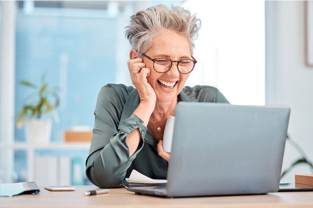 Laptop, coffee and senior business woman laughing