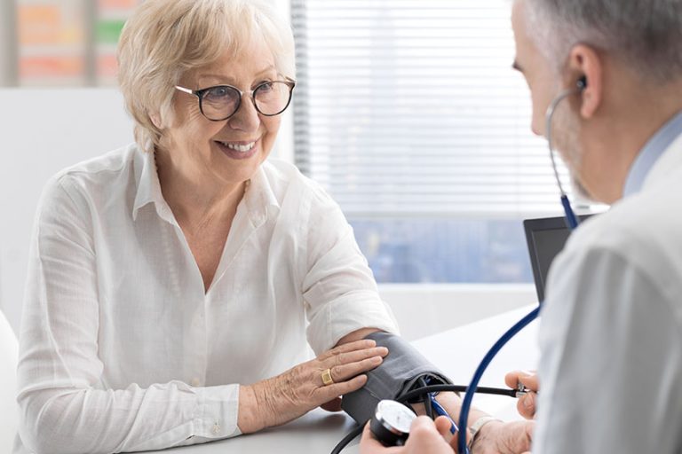 Professional doctor measuring a patient’s blood pressure Professional doctor measuring a patient's blood pressure