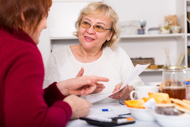 Cheerful elderly women with documents Cheerful elderly women with documents