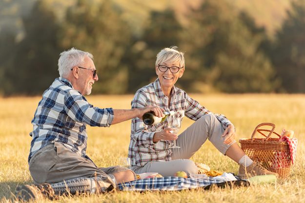 Senior couple having picnic in mountains Senior couple having picnic in mountains