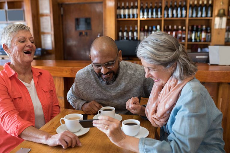 Friends looking their photos on phone Friends looking their photos on phone